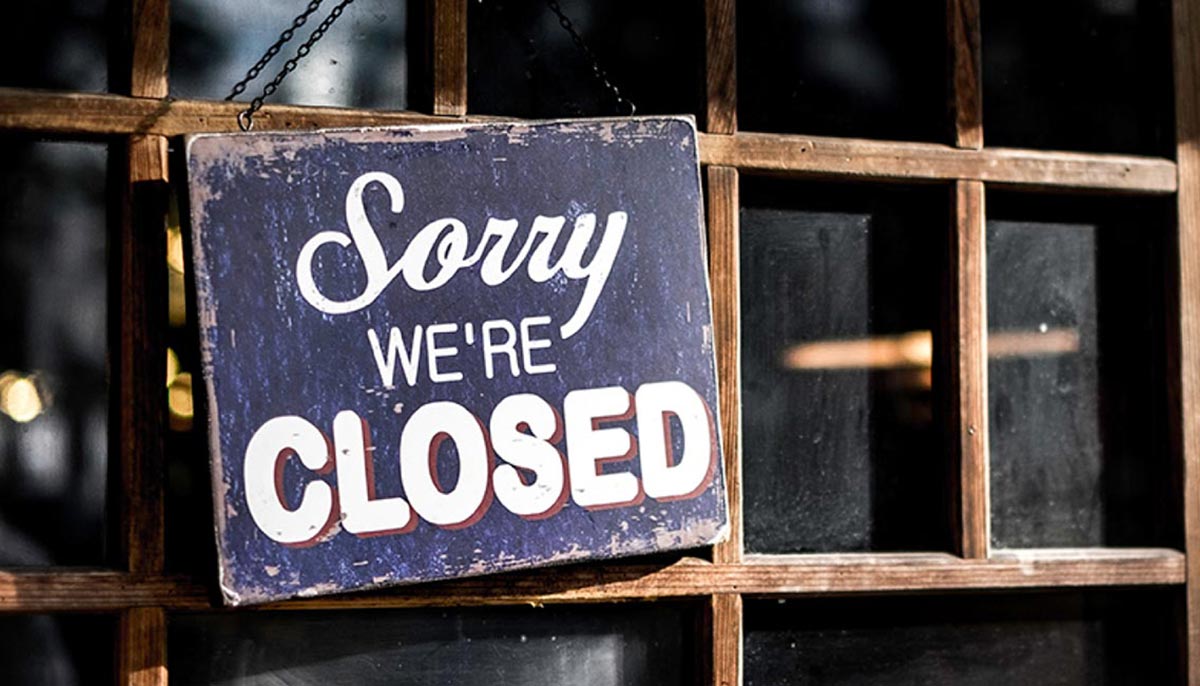 Sorry We're Closed sign on shop window
