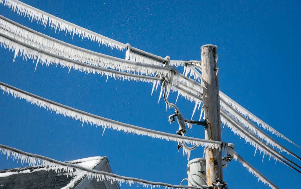 Utility pole and wires covered in ice